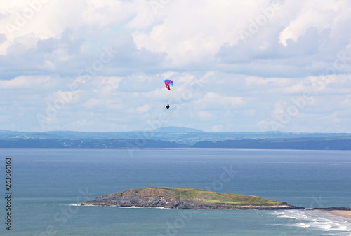 Paraglider flying at Rhossili, Wales