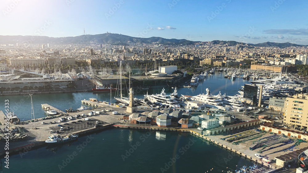 Aerial view of Barcelona city with port in sunny day
