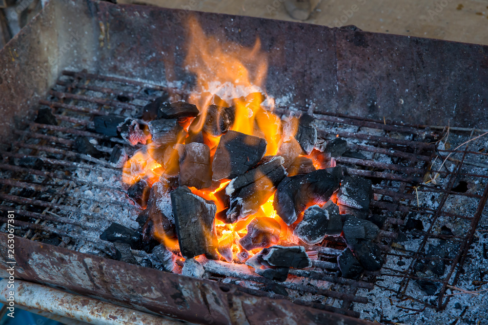 Stove charcoal.orange flames of coals in the grill / Charcoal stove burning.Brazier charcoal burning ready to grill in solid stove,feel cliam and warm at night. Stove charcoal.orange flames of coals in the grill / Charcoal stove burning.Brazier charcoal burning ready to grill in solid stove,feel cliam and warm at night.