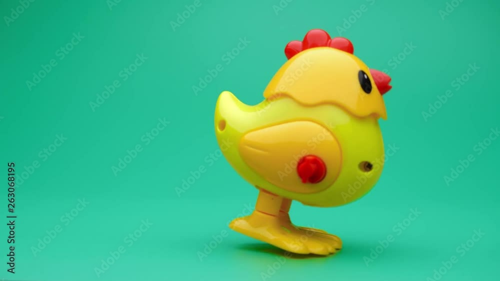 Clockwork chick toy hopping around. Slow motion. Clockwork chick toy hopping around. Slow motion.