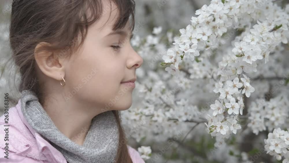 Asthma attack. Pollen allergy. A cute young girl uses an inhaler at the