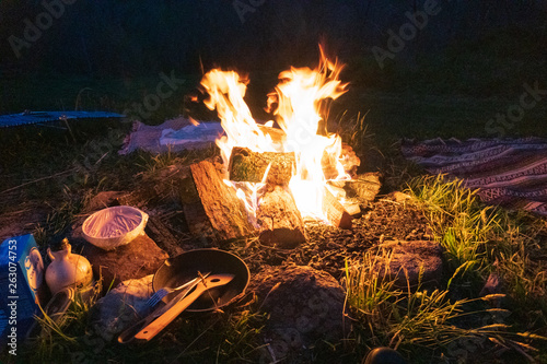 Bushcraft Campfire, Cast Iron Skillet, Camp Blankets and spatula at night. Pristine bon fire cooking in the Blue Ridge Mountains in Asheville, North Carolina. 
