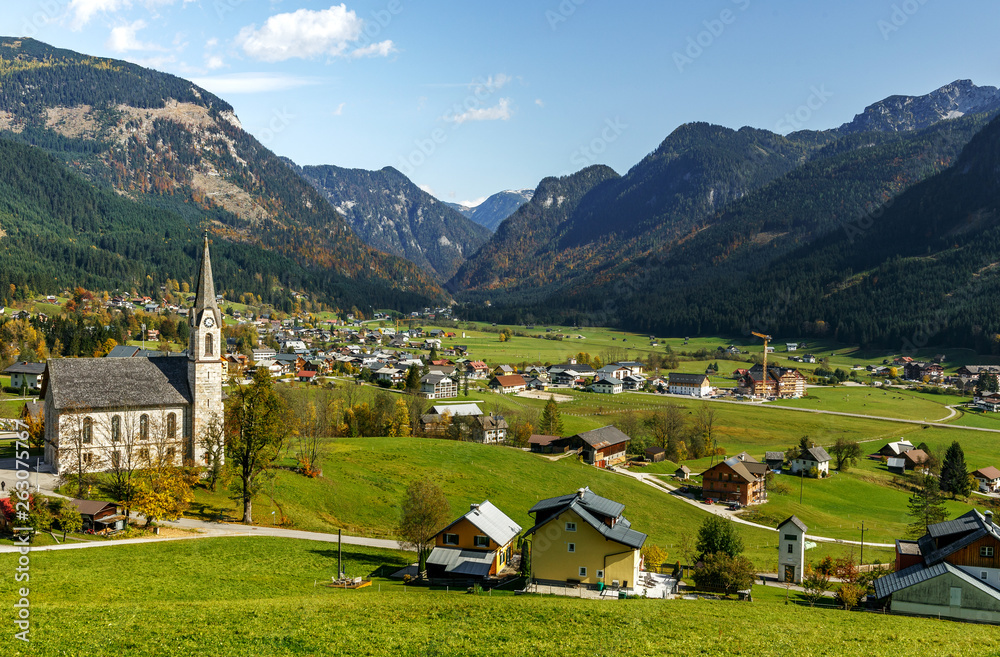 Awesome alpine highlands in sunny day. Wonderful Alpine Landscape. churh in Gosau village at sunny day. Alps, Austria, Europe. A magnificent panorama of the mountains. popylar touristic location