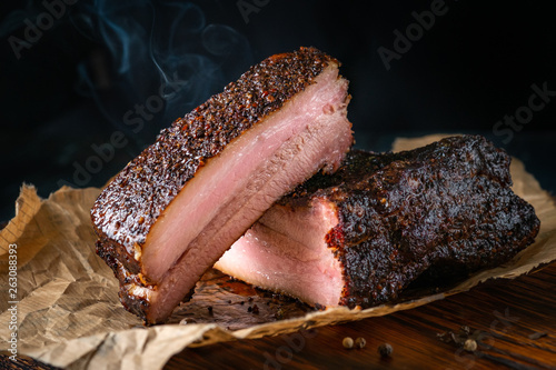 Photos Sliced smoked pork brisket with dark crust from classic Texas smokehouse