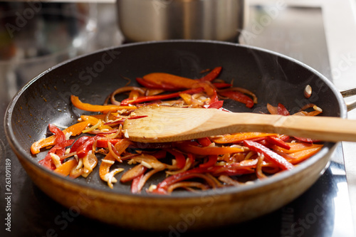 Vegetables fried on a skillet. Cooking. Making. Kitchen. Vegetables. Raw.