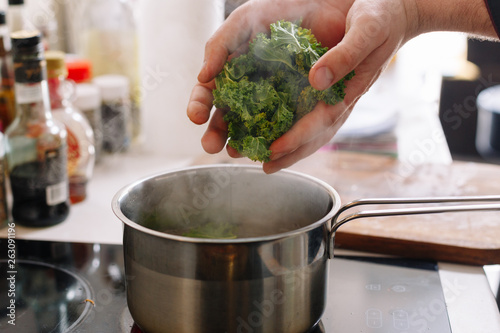 Cabbage boiled in pan. Arugula. Raw. Cooking. Making. Vegan. Green. Healthy food. 