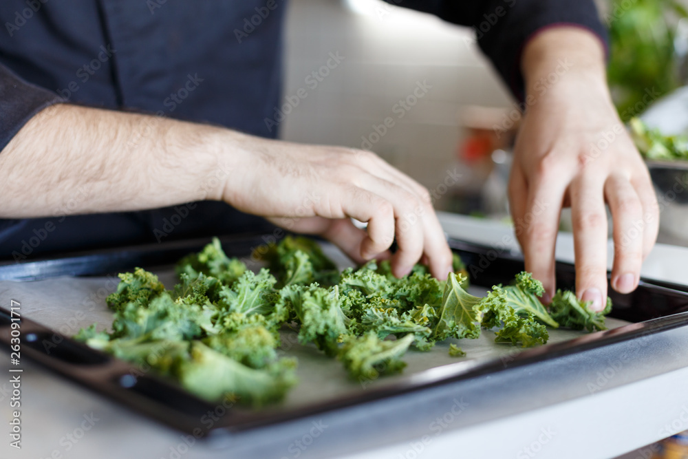 Cook lays out arugula. Baking. Baked. Process. Green. Raw. Homemade. Kitchen. Hands chef. Cook lays out arugula. Baking. Baked. Process. Green. Raw. Homemade. Kitchen. Hands chef.