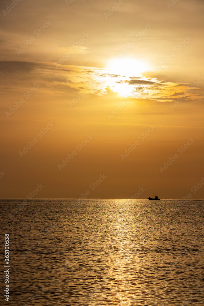 Golden summer Adriatic Sea sunrise with a ship at Senigallia, Province of Ancona, Marche, Italy