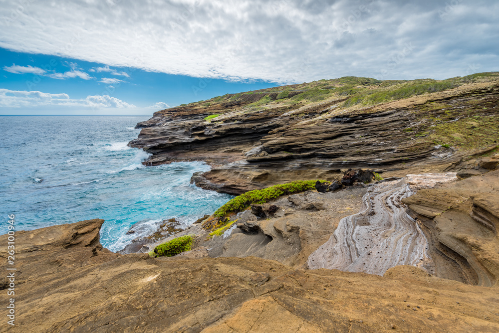 Ocean waves swirling around the unique lava rock formations of the Lanai Lookout on Oahu, Hawaii