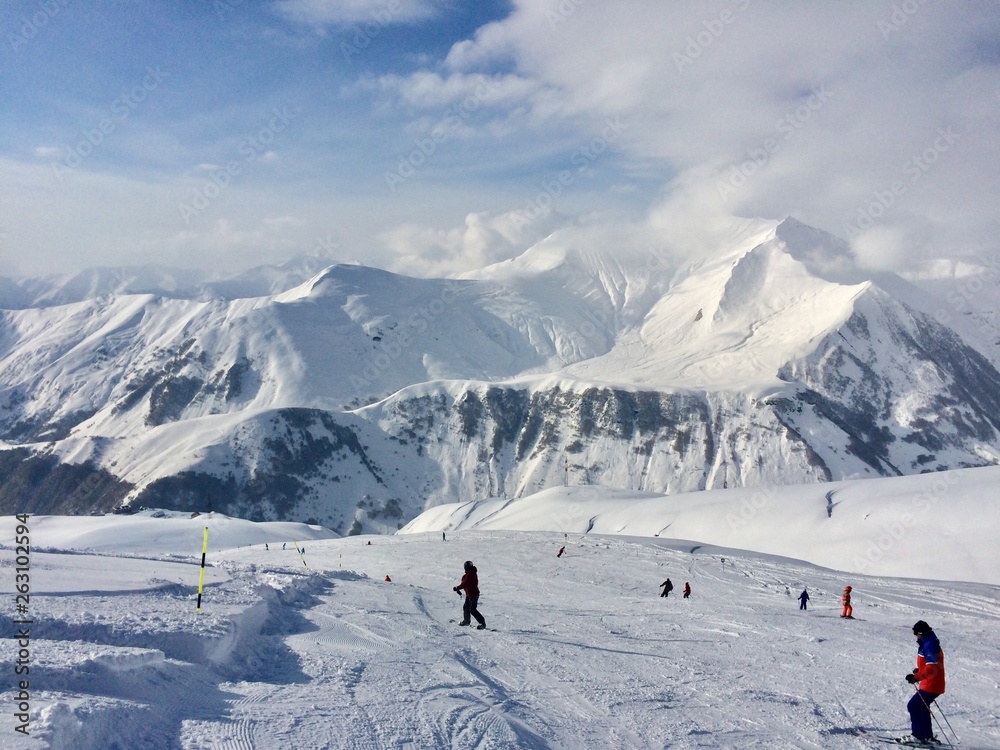 skiers in the mountains