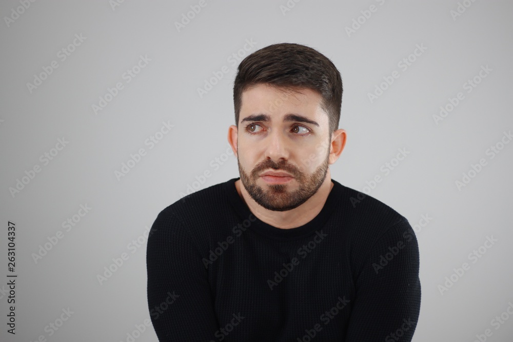 Obraz premium apprehensive and distrustful man looking at the fearful, distressed and agonized side - whit space for caption or text