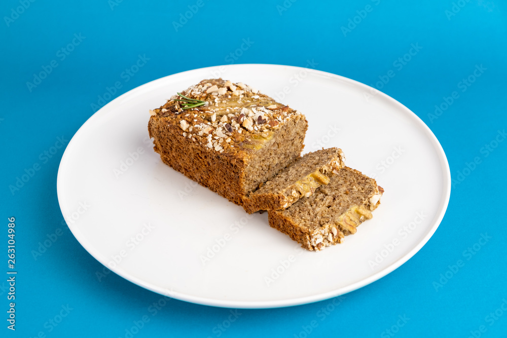 Almond bread loaf with Almond diced and Banana sliced set on Blue Background.