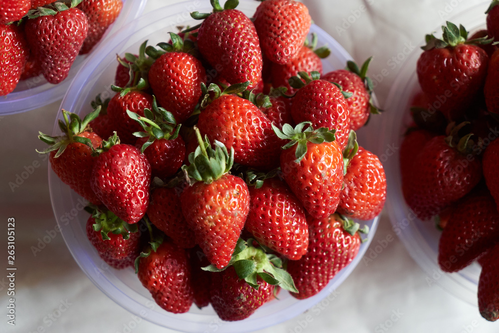 Fresh strawberry in a plastic bowl, close-up, top view, healthy detox food Fresh strawberry in a plastic bowl, close-up, top view, healthy detox food