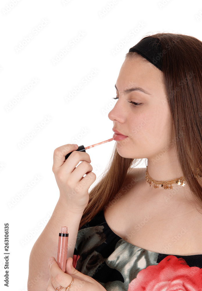 Pretty teenager girl fixing her lips in profile Pretty teenager girl fixing her lips in profile