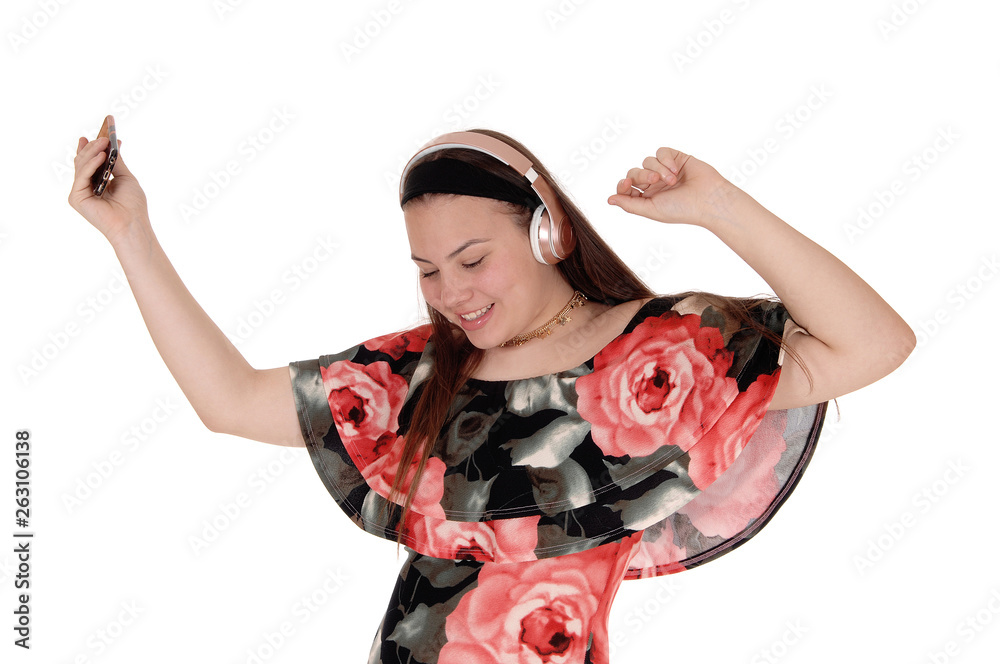 Teenager girl dancing with music from her earphone Teenager girl dancing with music from her earphone