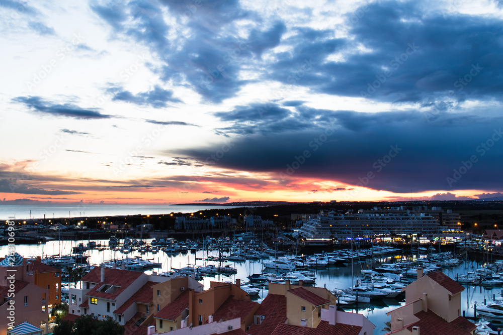 April 19th, 2019, Vilamoura, Portugal - aerial view of the marina during sunset on a cloudy day