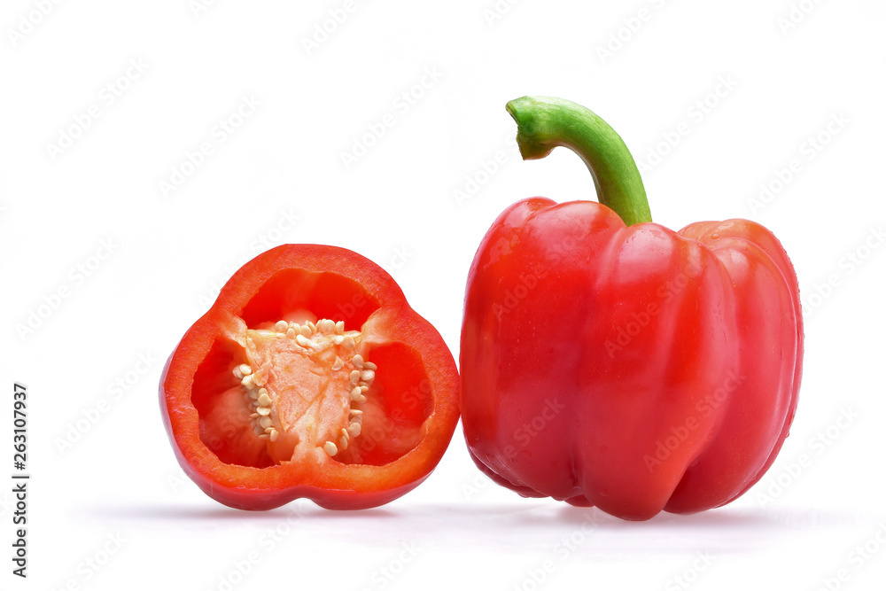 Appetizing composition of a whole Bulgarian pepper with a green stem and pepper halves on a neutral white background Appetizing composition of a whole Bulgarian pepper with a green stem and pepper halves on a neutral white background