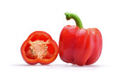Appetizing composition of a whole Bulgarian pepper with a green stem and pepper halves on a neutral white background