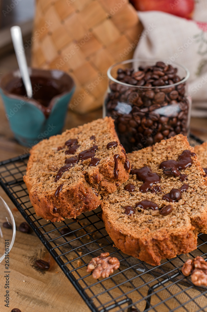 Fototapeta premium Cake with cocoa and chocolate on a wooden table. Sweet homemade pastries for breakfast. Rustic style photo.