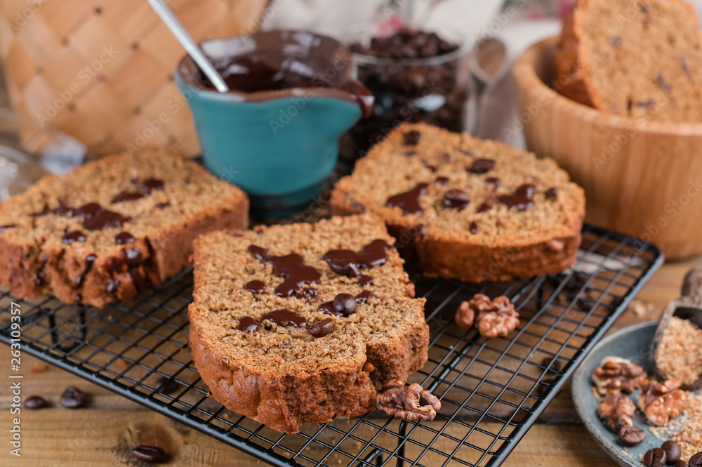 Cake with cocoa and chocolate on a wooden table. Sweet homemade pastries for breakfast. Rustic style photo. Cake with cocoa and chocolate on a wooden table. Sweet homemade pastries for breakfast. Rustic style photo.