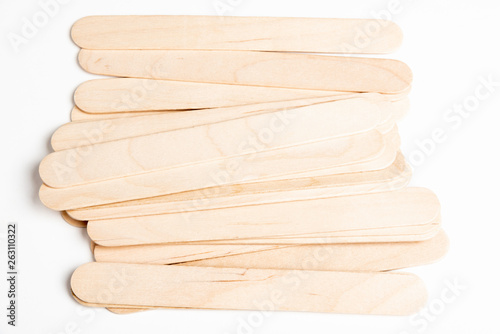 A stack or pile of wood sticks used for arts and crafts set on a plain white background