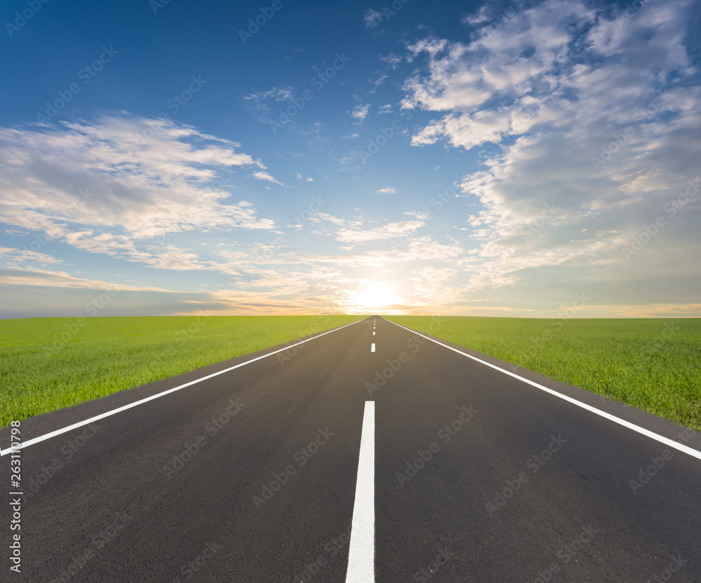 asphalt road among a green fields at the sunset, natural road background asphalt road among a green fields at the sunset, natural road background