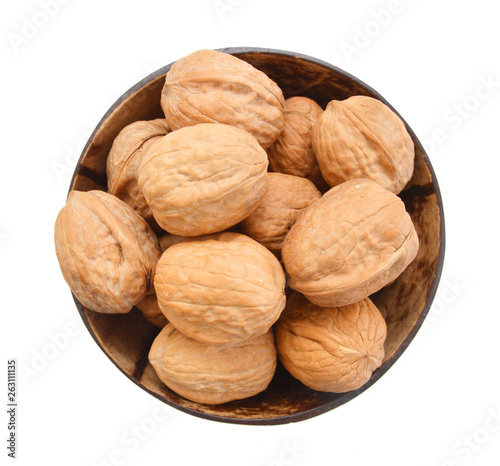 walnuts in wooden bowl on white background