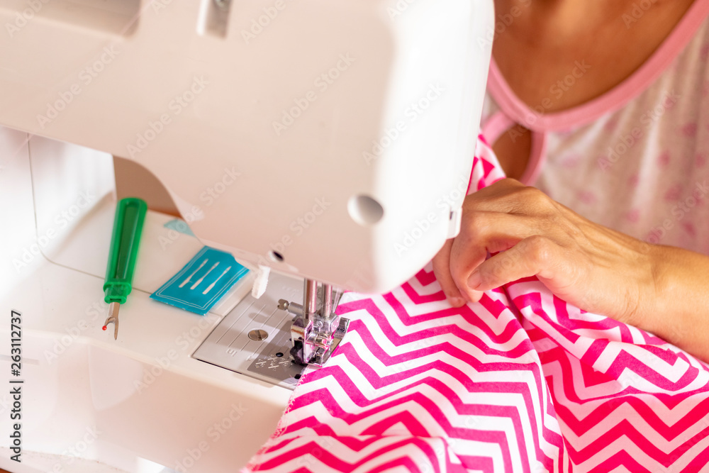 Seamstress woman working with her sewing machine Seamstress woman working with her sewing machine
