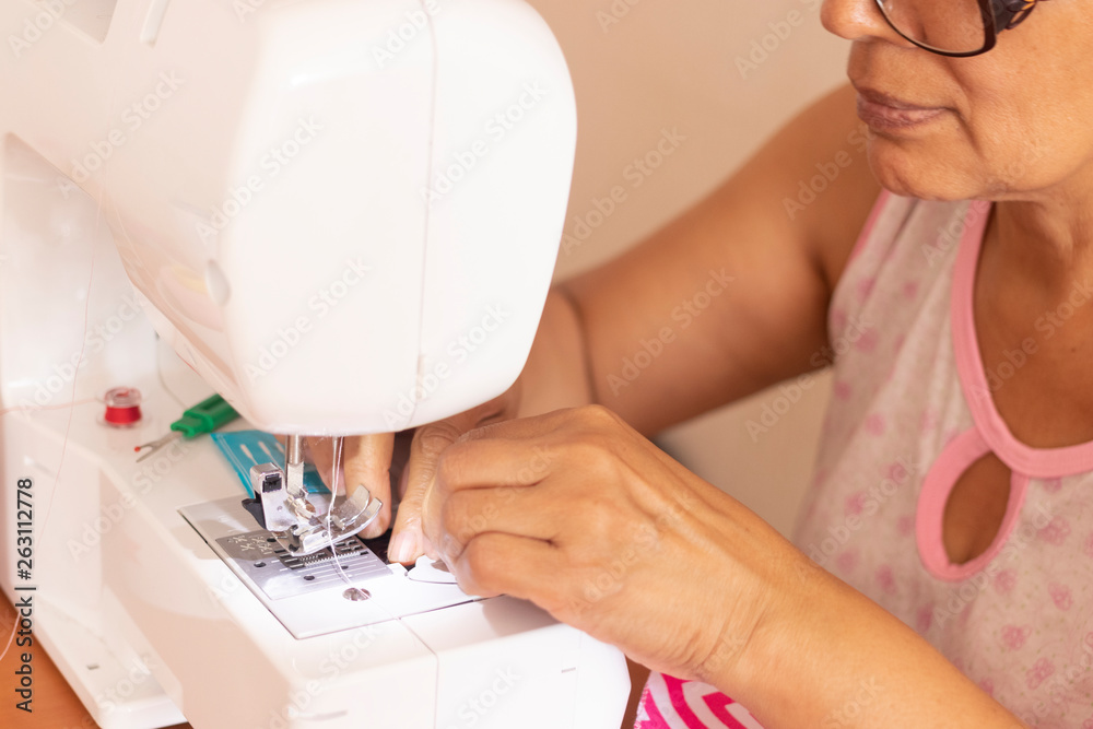 Seamstress woman working with her sewing machine