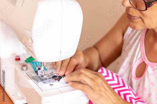 Seamstress woman working with her sewing machine