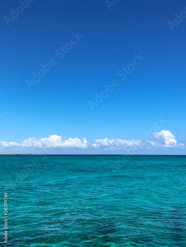 Turquoise sea background with clouds. 