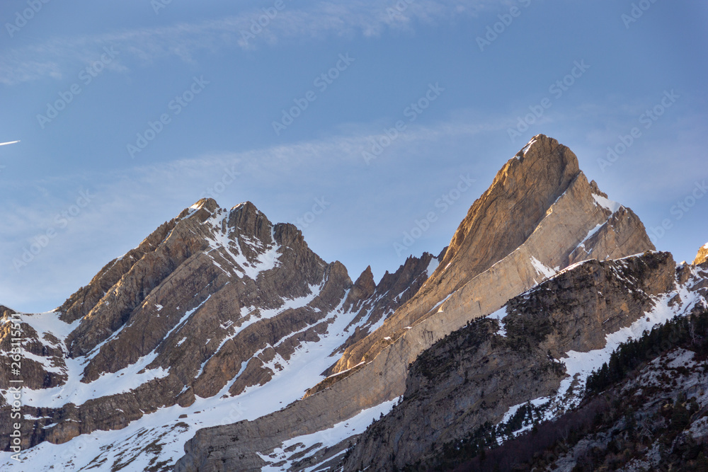 Obraz premium Sharp edge mountain peaks with some snow showing the climbing rock