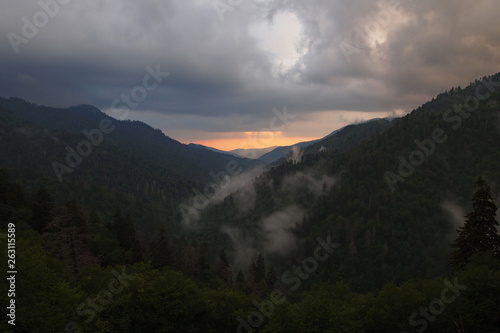 Sunset behind layered mountains under a dramatic cloudscape in the Great Smoky Mountains National Park, Tennessee, in early summer.