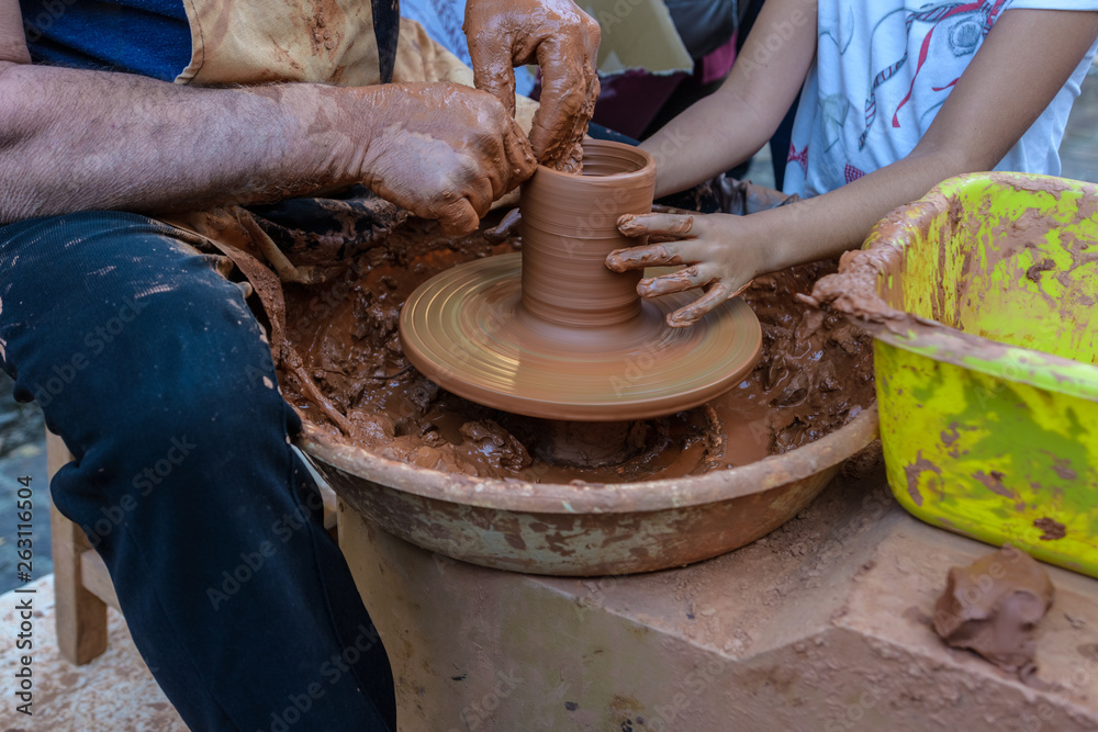 Potter teaches children at craft fair