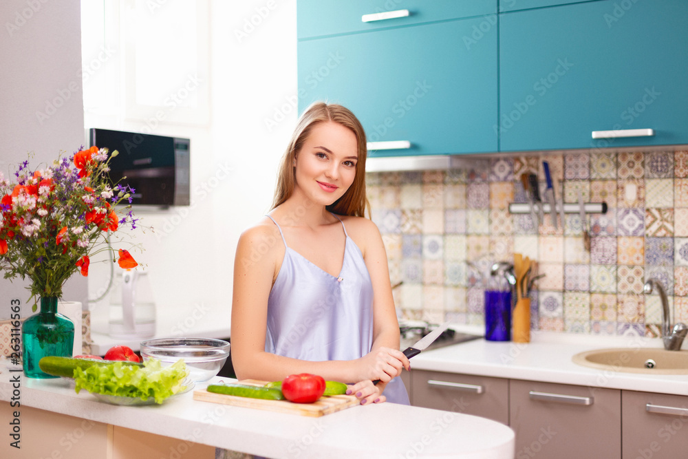 beautiful girl making salad in the kitchen beautiful girl making salad in the kitchen