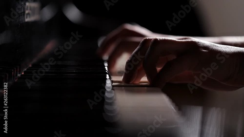 Closeup of the hands of a girl playing the piano instrument keyboard musician. Pianist sound concert