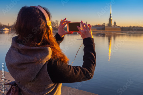 Saint Petersburg. Girl tourist photographs the sights in St. Petersburg. Travels in Russia. Peter-Pavel's Fortress. Neva River. Travel to Petersburg. photo