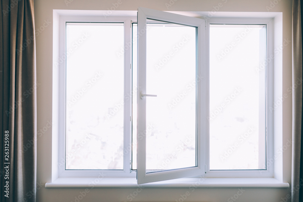 Close up opened white plastic pvc window at home Close up opened white plastic pvc window at home