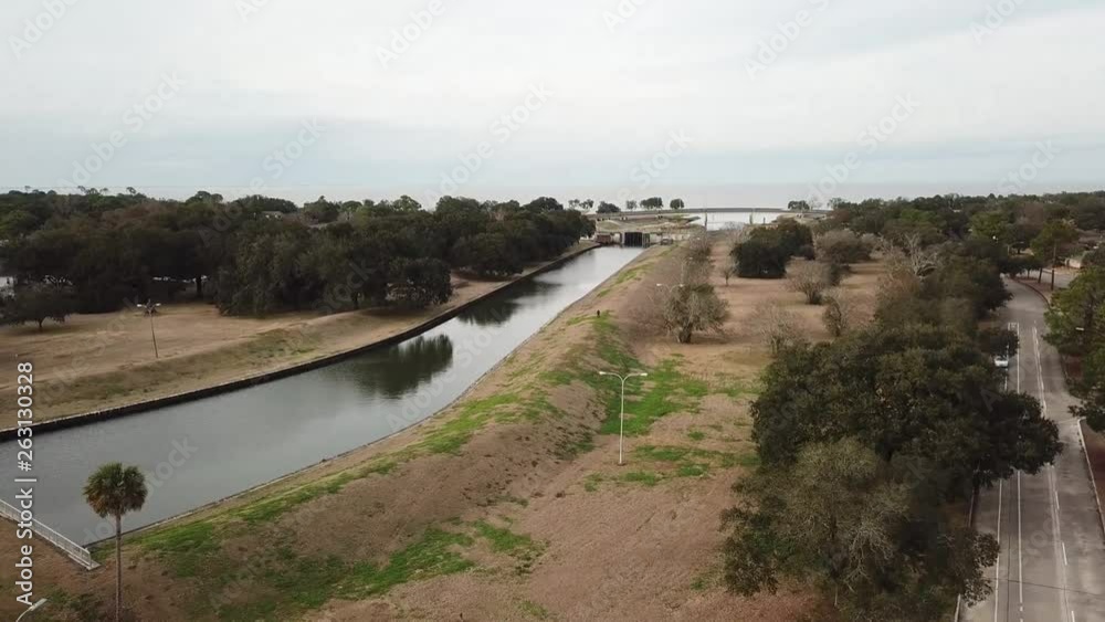 Aerial Drone Flying Over Water Canal in New Orleans Louisiana With Dike Stopbank and Trees Aerial Drone Flying Over Water Canal in New Orleans Louisiana With Dike Stopbank and Trees