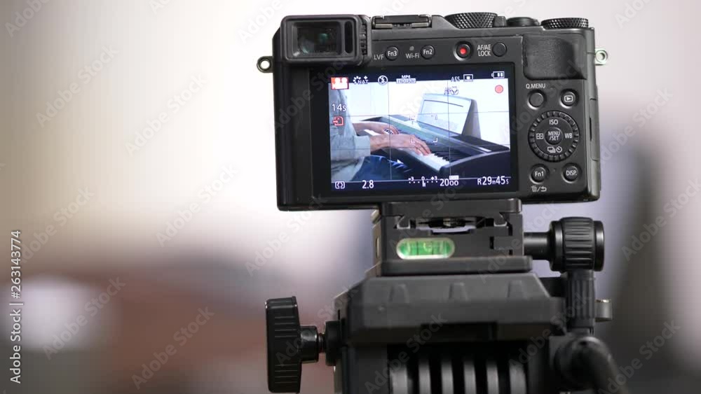 Musician vlogger recording a video of himself to post it on social media to be viewed by many viewers. Musician vlogger recording a video of himself to post it on social media to be viewed by many viewers.