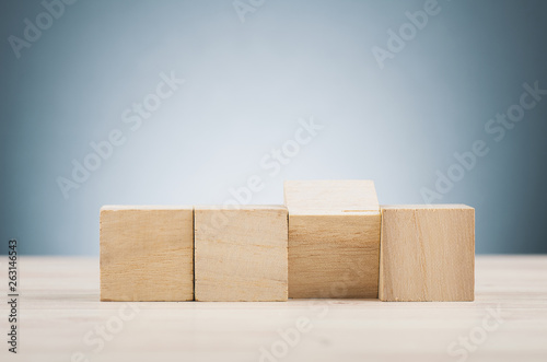 wooden cube on desk over beautiful reverberation gradient background
