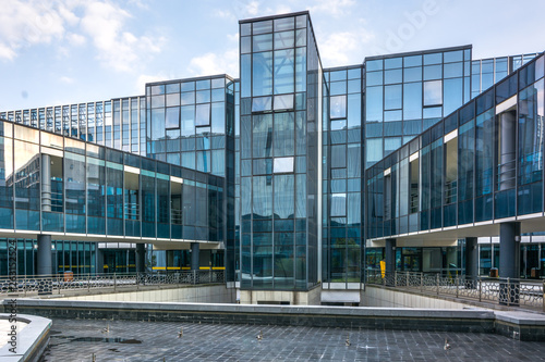 Rishon LeZion, Israel-June 17, 2017: 5 story office building of National Insurance Institute. The building face with yellow stone tiles each side of the building has a central leaded glass section.