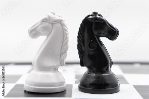 two chess knights turned back to each other. There is a white background for placing posts