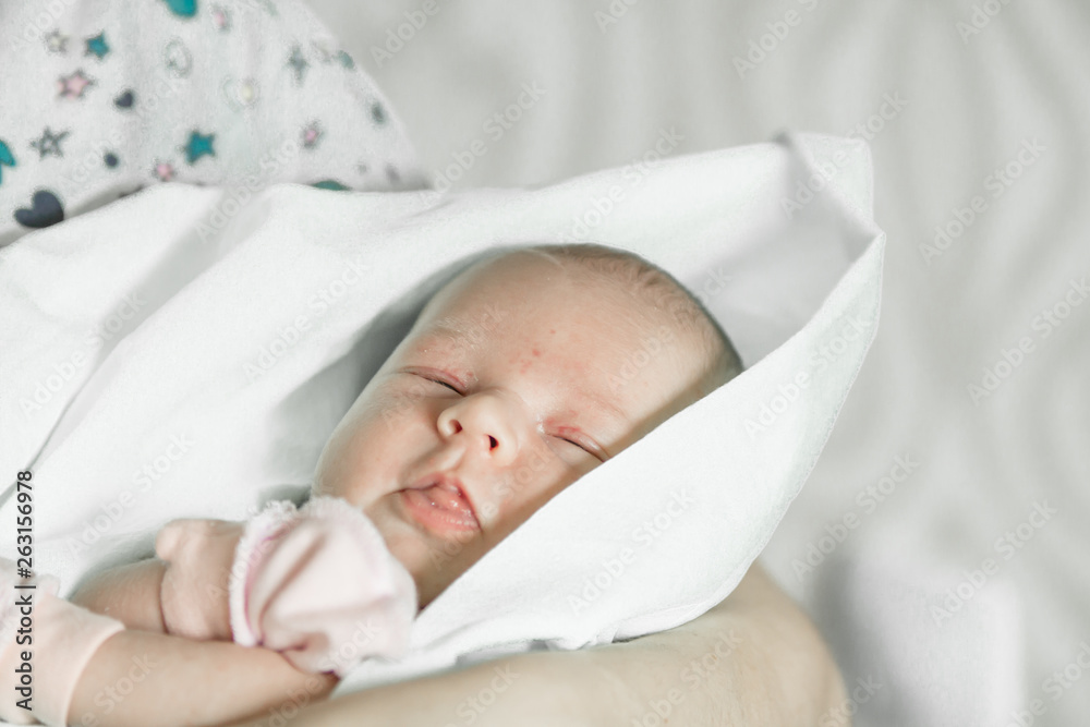 Sleeping newborn baby closeup portrait in mother's hands Sleeping newborn baby closeup portrait in mother's hands