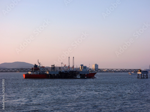 Incheon coastline  South Korea  under the background of sunset and blue sky  with ships sailing  city horizon.