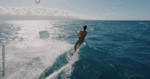 Young athletic man kitesurfing POV follow cam, extreme action sports POV, tropical island surf adventure