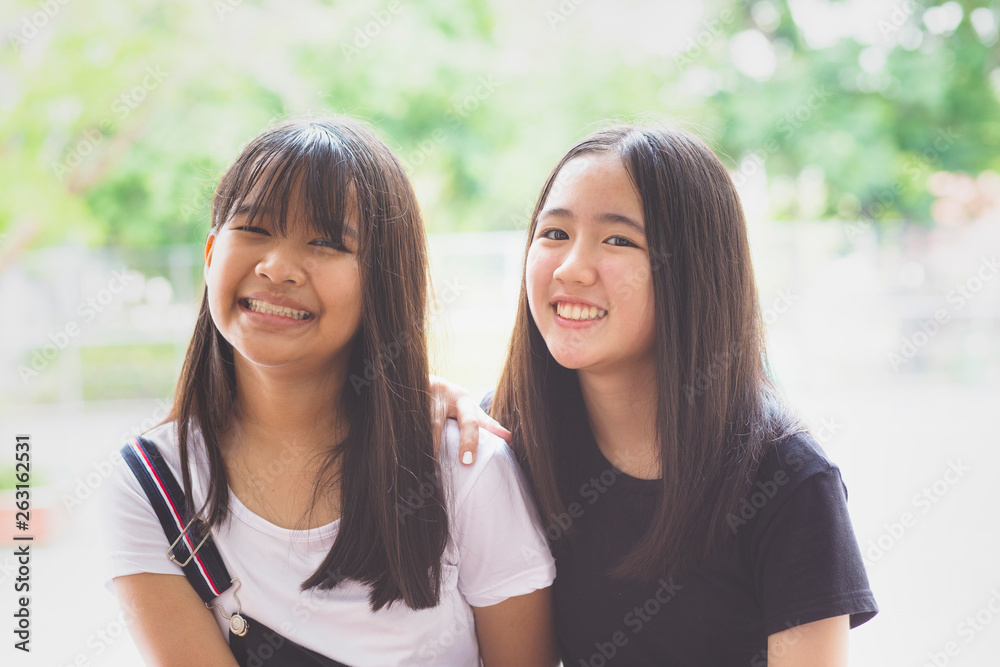 toothy smiling face happiness emotion of two asian teenager toothy smiling face happiness emotion of two asian teenager