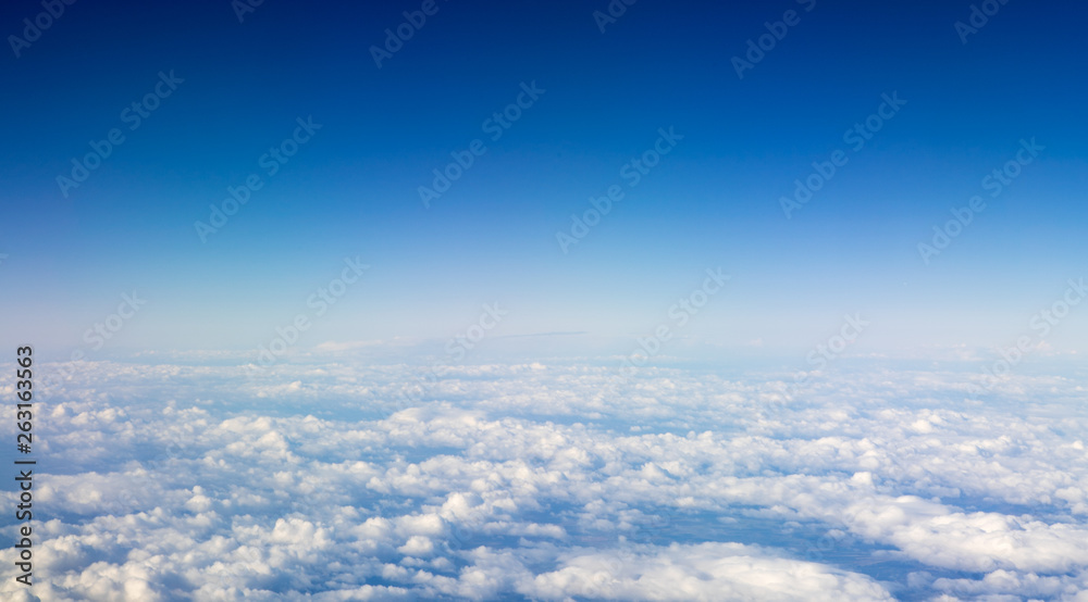 The beautiful cloudscape with clear blue sky. A view from airplane window. The beautiful cloudscape with clear blue sky. A view from airplane window.