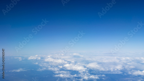 The beautiful cloudscape with clear blue sky. A view from airplane window. © REC Stock Footage