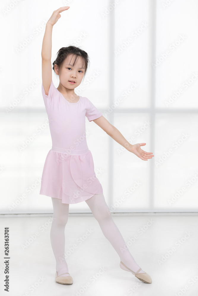 Pink dressed Asian girl in a ballet pose..